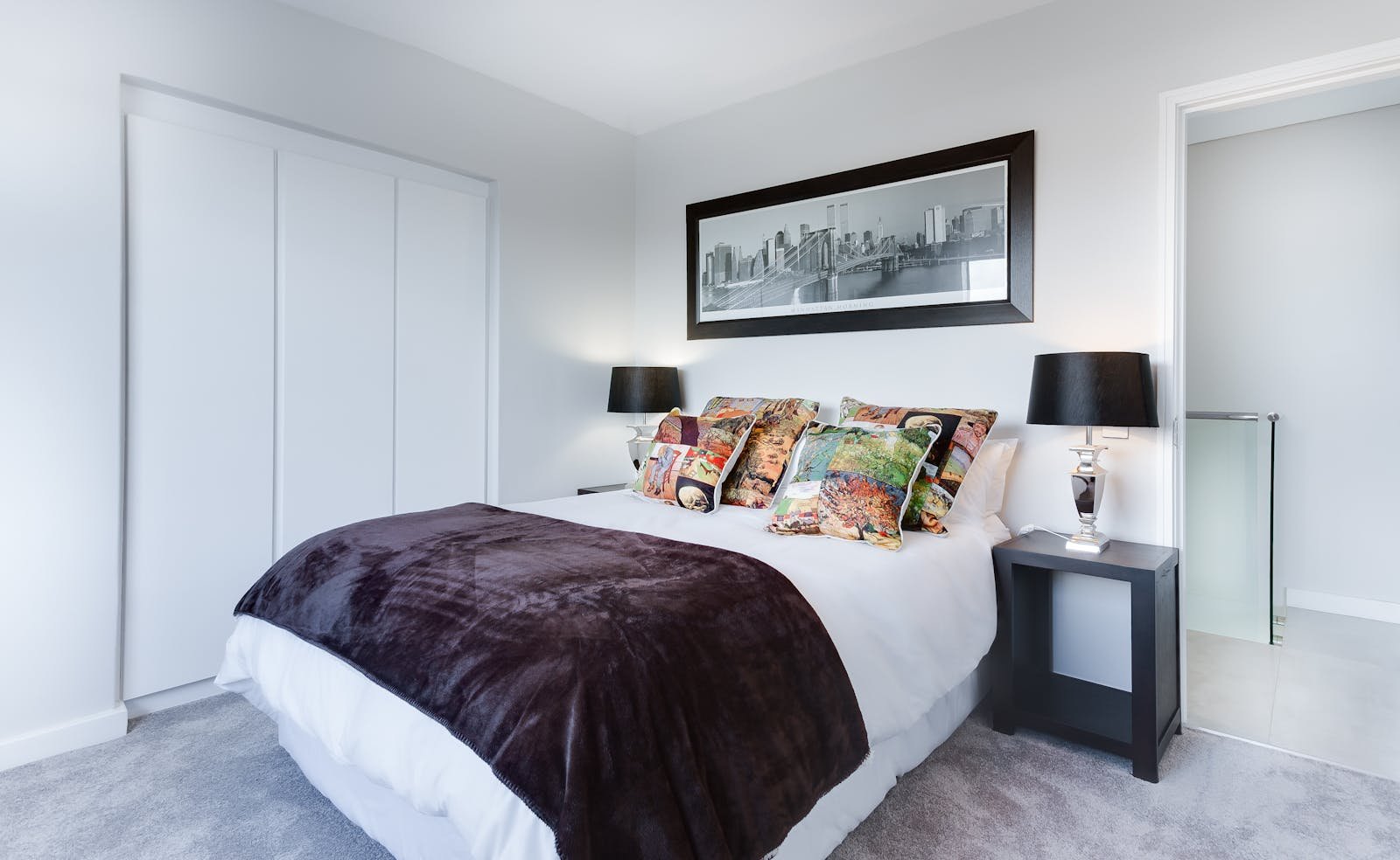Modern bedroom with platform bed frame and white linens