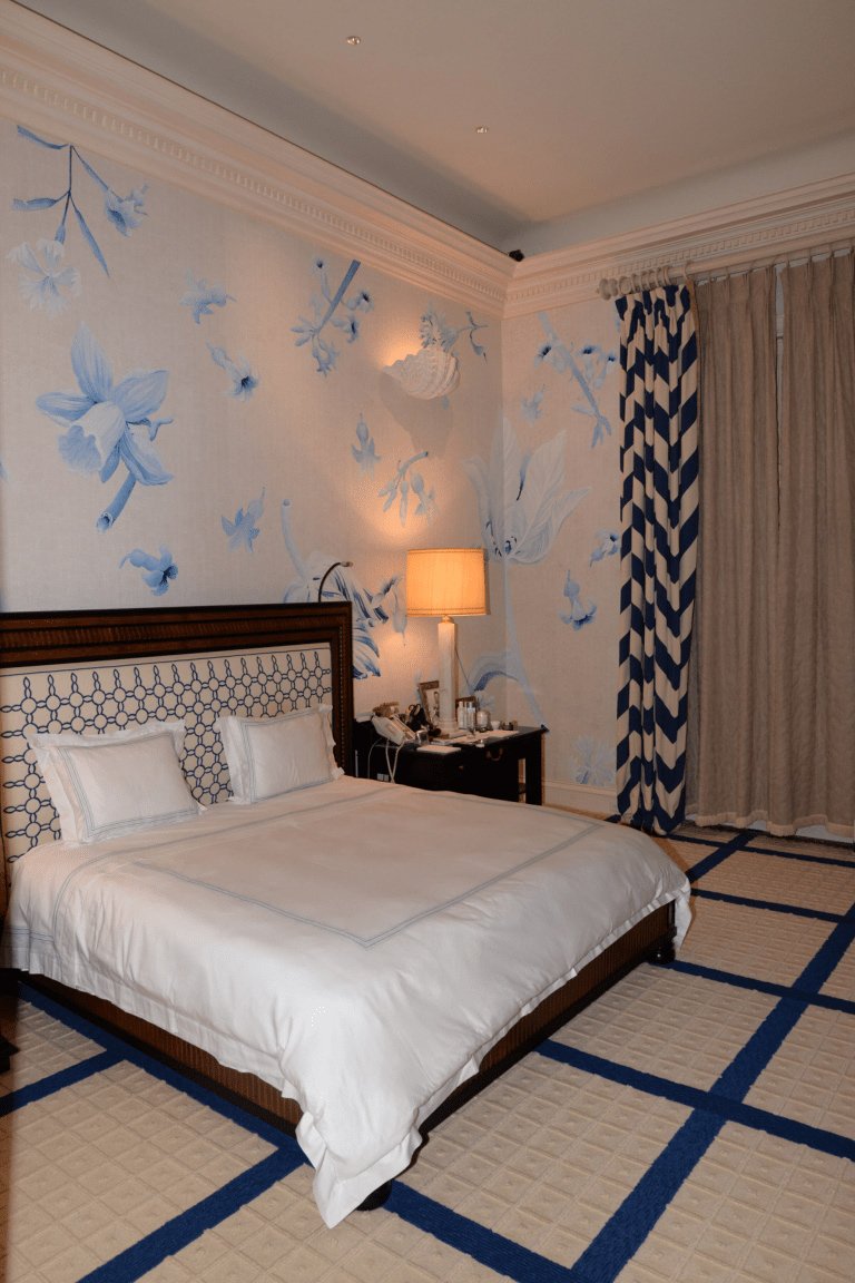 A mattress with fresh linens in a bright bedroom